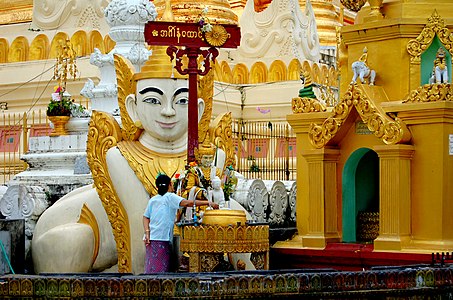 The planetary post for Tuesday, associated with the lion, at the Shwedagon Pagoda. A Burmese sphinx[8] (Manussiha) statue stands in the background.