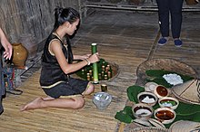 Traditional rice wine been served by using bamboo as a drink cup in Kota Kinabalu, Sabah, Malaysia. This is part of the Kadazandusun cuisine. Kota Kinabalu, E. Malaysia, demonstration of traditional rice wine making, 2013.jpg