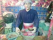 Sculpture of a meat Vendor surrounded by pots