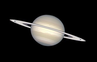 The ring orbiting Saturn consists mostly of chunks of ice and dust. The small dark spot on Saturn is the shadow from Saturn's moon Enceladus. Saturn in natural colors (captured by the Hubble Space Telescope).jpg