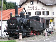 A steam locomotive mounted on a platform as a monument