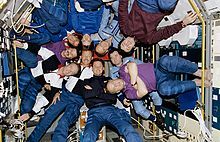 Ten people inside Spacelab Module in the Shuttle bay in June 1995, celebrating the docking of the Space Shuttle and Mir. Crewmembers of STS-71, Mir-18 and Mir-19 Pose for Inflight Picture - GPN-2002-000061 rotated.jpg