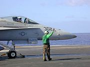 F/A-18 attached to catapult on the flight deck of USS Abraham Lincoln.