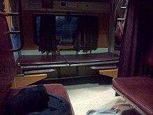 Train compartment with two seats and a bed