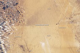 A clearly visible line marks about 80 kilometers (~50 mi) of the international border between Egypt and Israel in this photograph from the International Space Station. The reason for the color difference is likely a higher level of grazing by the Bedouin-tended animal herds on the Egyptian side of the border. Israel-Egypt-Gaza border region.jpg