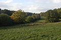 Looking west- north-west towards and over water meadows, with High Wood and Slockett's Copse on the right and Dirty Ground Copse on the left.