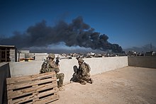 U.S. Army Soldiers, deployed in support of Combined Joint Task Force - Operation Inherent Resolve, assigned to 2nd Battalion, 325th Airborne Infantry Regiment, 2nd Brigade Combat Team, 82nd Airborne Division, use a rooftop as an observation post in Mosul Iraq, 7 March 2017. U.S. Army Soldiers, deployed in support of CJTF-OIR, assigned to 2nd BN, 325th AIR, 2nd BCT, 82nd Airborne Division, use a rooftop as an OP in Mosul, Iraq, March 7, 2017.jpg