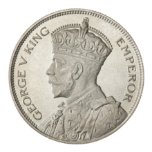 A crowned portrait of George V in royal dress, with the encircling text GEORGE V KING to the left, and EMPEROR to the right.