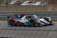A grey, red and blue racing car
