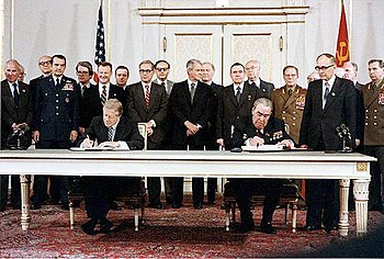 President Jimmy Carter and Soviet General Secretary Leonid Brezhnev sign the Strategic Arms Limitation Talks (SALT II) treaty, 16 June 1979, in Washington D.C.  Zbigniew Brzezinski is directly behind President Carter and is the only person smiling in the picture.