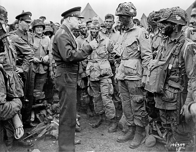 General Eisenhower speaks with members of the ...