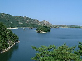 Lake with small islands lined by mountains
