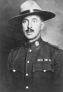 A young man with a moustache, wearing a police serge and stetson hat