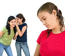 A girl feeling ashamed as two other girls taunt behind her back Taunting 0001.jpg