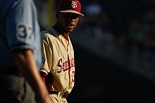 Florida State players wear gold uniforms in games that are played on Sundays. FSU 3B Sherman Johnson. (7390397138).jpg