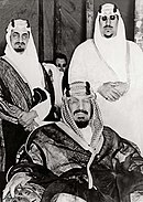 King Ibn Saud of Saudi Arabia with two of his sons King Abdulaziz with Prince Faisal and Prince Saud.jpg