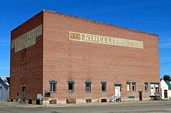 Photograph of the J. C. Palumbo Fruit Company Packing and Warehouse Building, a large, brick, blocky, mostly windowless building