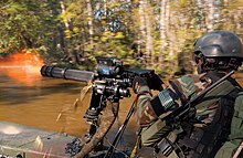 U.S. Special Warfare combatant-craft crewman use a rotating barrel minigun on the SOC-R to lay down suppressing fire during a practice "hot" extraction of forces on a beach. Special forces gatling gun.jpg