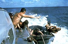 Underwater Demolition Team members using the casting technique from a speeding boat US Navy SEALs SEAL jumps over side boat.jpg