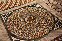 intricately patterned floor with coloured marbles