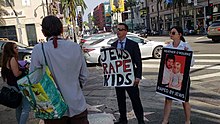 Patrick Little holding an antisemitic sign on a street corner in Los Angeles (August 2018) Man holds hateful sign in Beverly Hills.jpg