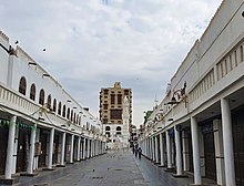 Market street in old Jeddah with al-Mimar Mosque in the background, Saudi Arabia (1) (50703470911).jpg