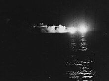 HMNZS Leander fires on the Japanese cruiser Jintsu. USS St. Louis (CL-49) and HMNZS Leander firing during the Battle of Kolombangara, 13 July 1943 (80-G-342763).jpg