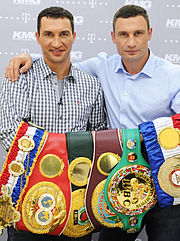 Wladimir Klitschko and Vitali Klitschko with every title in the heavyweight division, 2012. Left to right: The Ring, IBF, IBO, WBO, WBC, and WBA. VladimirVitaliy.jpg