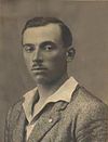 black&white studio photo of a man looking directly into the camera