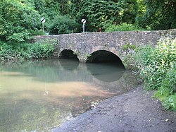 Stone two arch bridge over water