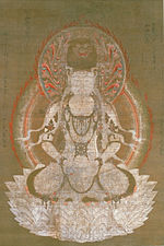 Frontal view of a deity seated on a pedestal.