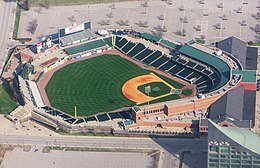 An aerial view of a green baseball field and the surrounding grandstand