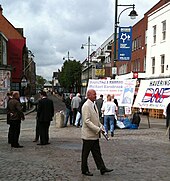 Nick Griffin, leader of the British National Party, talking to voters in Romford Market. Nick Griffin, talking to voters.jpg