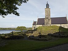 Chapel, bell tower and penitential beds on Station Island. The bell tower stands on a mound that is the site of a cave which, according to various myths, is an entrance to a place of purgatory inside the Earth. The cave has been closed since October 25, 1632. Station Island.jpg