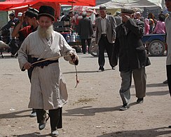 Uyghur man in traditional costume at Kashgar Sunday Market.
