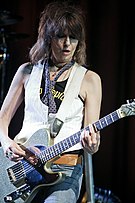 Chrissie Hynde playing guitar onstage