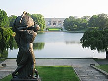 View of the museum from the steps of the Euclid Avenue entrance to Wade Park, overlooking the Lagoon. Seen in the foreground is Frank Jirouch's 1928 bronze sculpture, Night Passing the Earth to Day. Cleveland Museum of Art - lagoon with statue.jpg