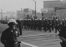Vietnam War draft evasion march in Oakland, led by David Harris in 1967. Police, Stop the Draft Week (cropped).jpg