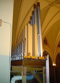 A view from behind the case of the organ at St. Raphael's Cathedral in Dubuque shows some of the pipes, the interior of the case, and part of the wind system.