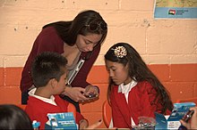 Teacher showing primary school students how to work a program at a primary school in Santa Fe, Mexico City 03212012Matitec entrega dispositivos santafe083.jpg