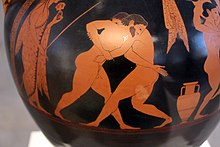 Vase antique à fond noir : deux hommes luttant.