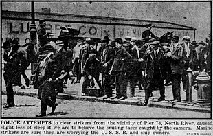 Caption reads, Police attempts to clear strikers from the vicinity of Pier 74, North River, caused slight loss of sleep if we are to believe the smiling faces caught by the camera. Marine strikers are sure they are worrying the U.S.S.B. and ship owners.