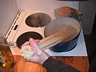 Uncut ziti being set into a pot