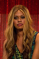 A black woman with long, straightened hair containing blonde highlights
