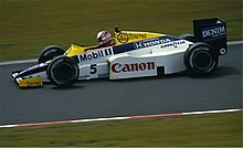 Photo d'une monoplace de Formule 1, bleue, jaune et blanche, sur une piste de circuit