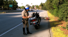 A California Highway Patrol motorcycle officer along the San Tomas Expressway through Santa Clara, California Motorcycle patrol officer along San Tomas Expressway, Santa Clara, California - 20060224.png