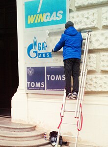 A worker removes the sign from Gazprom's office in Vienna in March 2022 Sign removal at Gazprom's Vienna office, March 2022.jpg