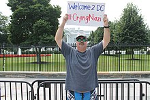 A counter-demonstrator holding a sign referring to Christopher Cantwell as the "Crying Nazi" in front of the White House on August 11, 2018 26a.WhiteHouse.WDC.11August2018 (30118579428).jpg