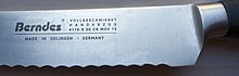 A contract manufacturer produced this knife with a protected geographical indication for a brand outside Solingen that usually sells cookware. Berndes Solingen bread knive marking hand forged 4116 X 50 CR MOV 15.jpg