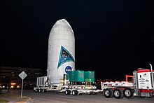 PACE spacecraft, encapsulated inside a Falcon 9 payload fairing, being transported to Space Launch Complex 40 on Thursday, Feb. 1, 2024 PACE Spacecraft Transport from Astrotech to SLC-40 (KSC-20240201-PH-JBS01 0036).jpg